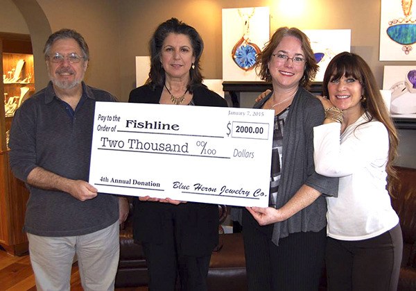 Representatives of Blue Heron Jewelry Company in downtown Poulsbo presented this check for $2