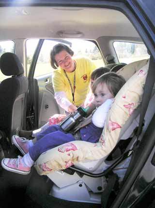NKF&R Volunteer and Car Seat Technician Nancy McClellan makes sure these two are riding as safely as possible at one of our monthly car seat checks.