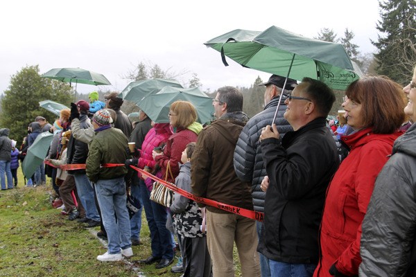 Hundreds of residents attended “Gather for the Green” Jan. 26 to show support for the fundraising effort for the new Village Green Community Center. Attendees made a human blueprint of the main walls of the center.