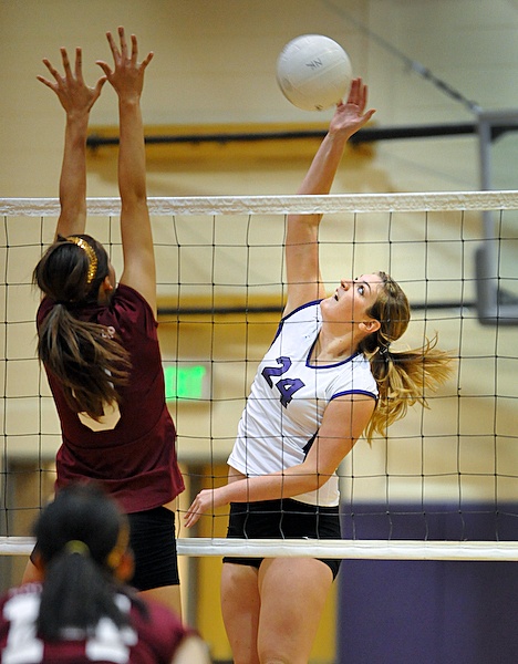 North Kitsap's Claire Torstenbo hits a shot as South Kitsap's Mallory Horch attempts to block during the Vikings' season opener Wednesday at North Kitsap High. The Vikings defeated the Wolves in three straight sets.