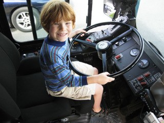 McKendree Springer is all smiles behind the wheel of a big rig during last year's Touch-a-Truck in event in Poulsbo