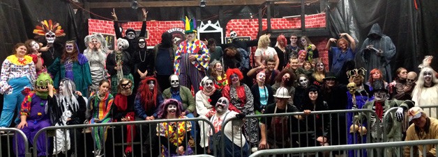 The volunteer cast of the Haunted Fairgrounds gather each night for a photo after the evening’s scares.