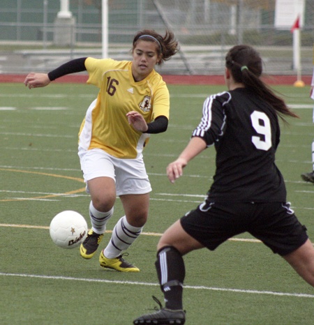 South Kitsap’s Stacey Smith breaks downfield on a Kentridge defender during the Wolves 1-0 playoff loss on Saturday.
