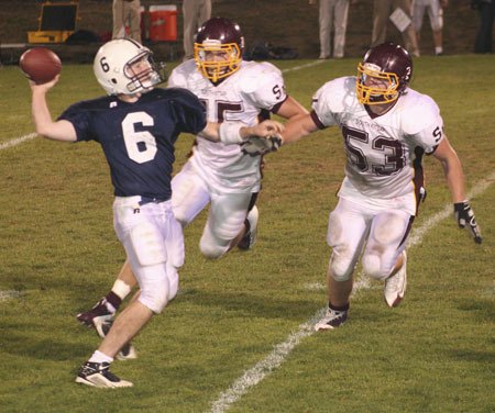 South Kitsap linebackers Austin Cook and Nick Boss zero in on Bellarmine’s quarterback during the Wolves’ 15-7 win on Friday night.