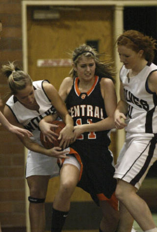 Central Kitsap’s Amanda Evans fights for the ball against Tori Fairweather (left) and Stephanie Osterdahl (right) of South Kitsap.  Evans finished with a team-high 17 points to lead the Cougars past SK for the 13th consecutive time