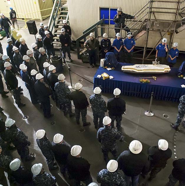Sailors from the USS Stennis celebrate the 18th anniversary of the commissioning of the ship with a cake shaped like the ship. Bremerton is the Stennis’ homeport.