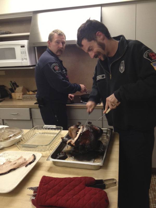 Aaron Rankin and Lt. Bill Green prepare turkey for the family-style dinner at the station. The crew of 19 at the CK Fire Station ate smoked turkey