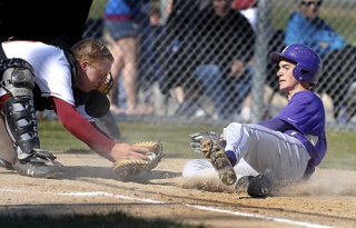 Kingston catcher Curtis Wildung tags North Kitsap's Zak Smit out at home Monday at Kingston. The Vikings won the game