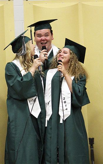 Three graduating seniors sing at Klahowya Secondary School's Friday commencement ceremony. The chorus sang 'Everything Must Change.'