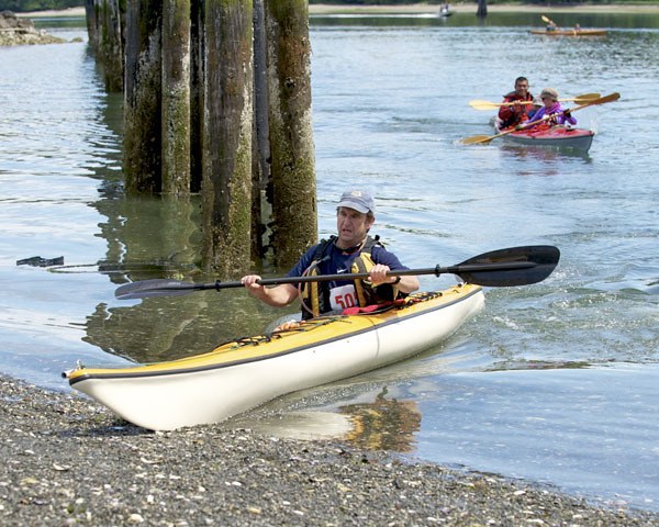 Dave Parker beaches his kayak after the 15K paddling leg of the Full-Beast triathlon