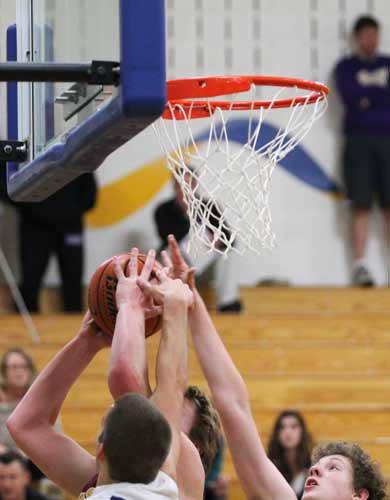 Kingston's Sam Byers attempts to break through the Bainbridge High School Spartan's defense Tuesday night during the Buccaneers' first basketball game of the 2011-12 school year.