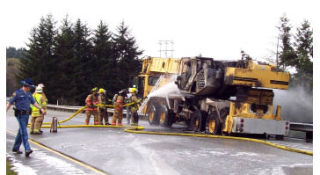 Firefighters from Central Kitsap Fire & Rescue and Navy Region NW Fire and EMS work to extinguish the flames after a crane truck caught fire on northbound State Route 3 near the Chico Way exit Tuesday.
