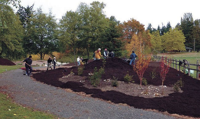 Volunteers spread mulch at a recent garden work party.