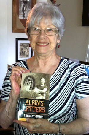 Rosie Atkinson hold a copy of her book