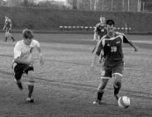 Bremerton defender Ritchie Danskin (6) closes in on Olympics Levi Hay in Tuesdays 4-3 overtime loss to the Trojans.