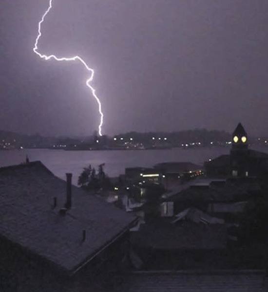 Port Orchard photographer Gary Patrons captured a brilliant lightning strike the night of June 20 while taking video of a rare thunderstorm light show from across Sinclair Inlet. City Hall is in the foreground.