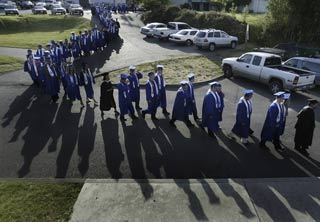 Olympic High School seniors make their way to the Pavilion at the Kitsap County Fairgrounds for graduation Saturday.