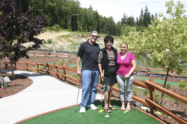 Kingston Greens owners Phillip and Carol Hoffman and resident manager Susan Myers pose on the practice green.