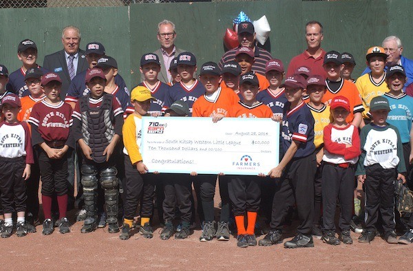 Players from the South Kitsap Western Little League hold up a $10