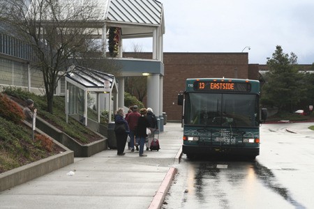 A bus pauses to take on more passengers at the Kitsap Mall Friday. Mall management informed Kitsap Transit it would have to move its stop at the mall within three months to make way for a new mall tenant.