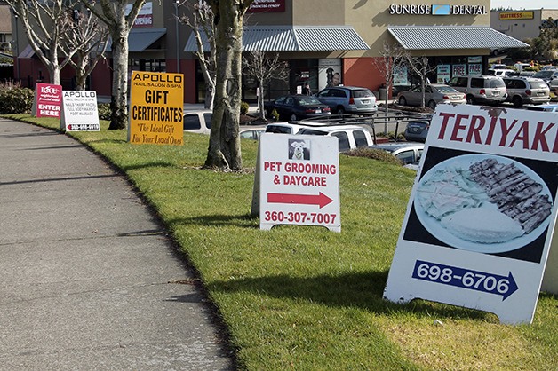 A-frame or sandwich board signs like those pictured will have to be no more than 15 feet from the entrance to the business that is advertised under a proposed new county sign code.