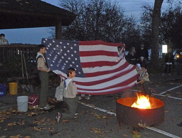 Boy Scouts from Troop 1541 display an American flag as it is prepared for a flag retirement ceremony in Silverdale on Veterans Day earlier this week.