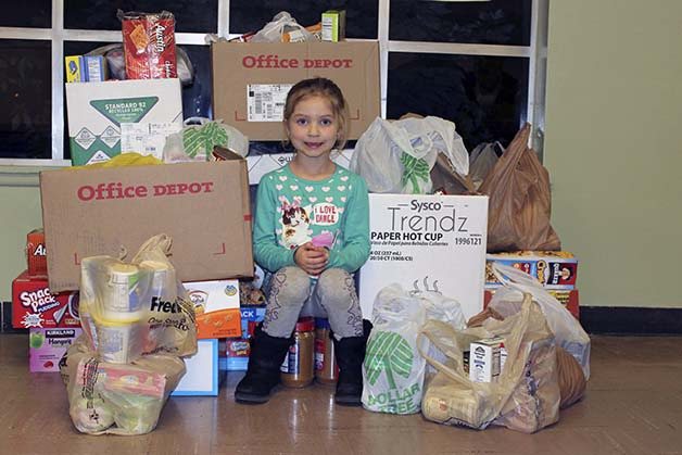 Kendall Runyan smiles at the food she collected recently.