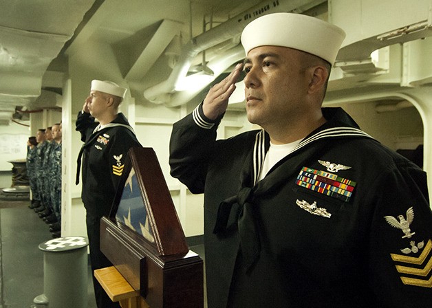 Chief (select) Machinist’s Mate Michael Kuhaneck and Chief (select) Aviation Ordnanceman Oscar Vera salute during a 9/11 remembrance aboard the USS John C. Stennis.