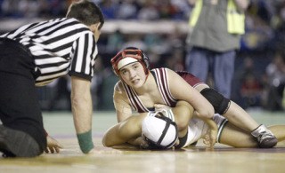 Kingston's Kiana Witt wrestled through an injured shoulder to take the 112-pound girl's state wrestling title 9-4 over Mount Vernon's Ricarda Garcia Saturday in the Tacoma Dome.