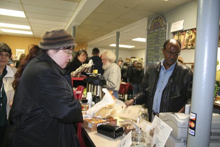 East Bremerton resident Brandy Williams buys groceries at FreshLocal from employee Semeon Yefru Nov. 19 at FreshLocal’s first birthday party. The Fourth Avenue store has been the only grocery downtown and is likely to stay that way for years to come.
