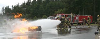 Local firefighters perform a live fire demonstration at Saturday's Kids' Day at the Kitsap County Fairgrounds.