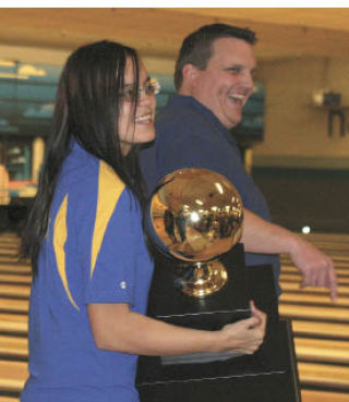 Then-senior Emmy Thomas holds the trophy after the BHS bowling team won the Class 2A/3A Girls Bowling Championship last season.