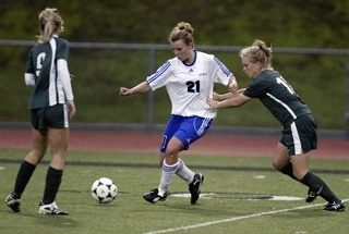 Olympic forward Audrey Pond (21) fends off a Shadle Park defender during the Lady Trojans' 1-0 first-round Class 3A state playoff victory at Silverdale Stadium Tuesday.