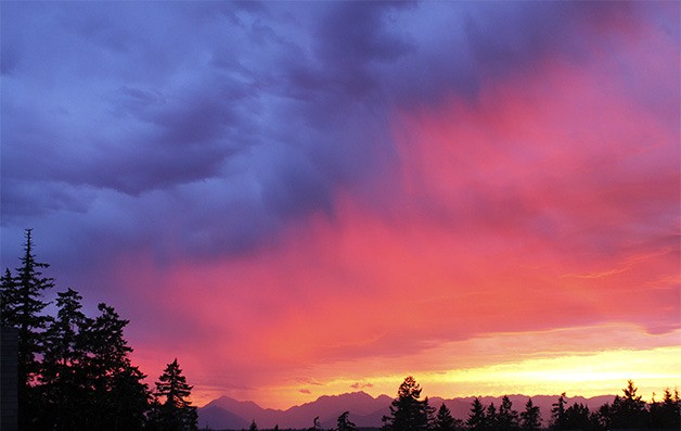 The sun sets as a thunderstorm rolls in over Silverdale on Sunday evening. The spectacular sunset came after a weekend of high temperatures and sunny skies.