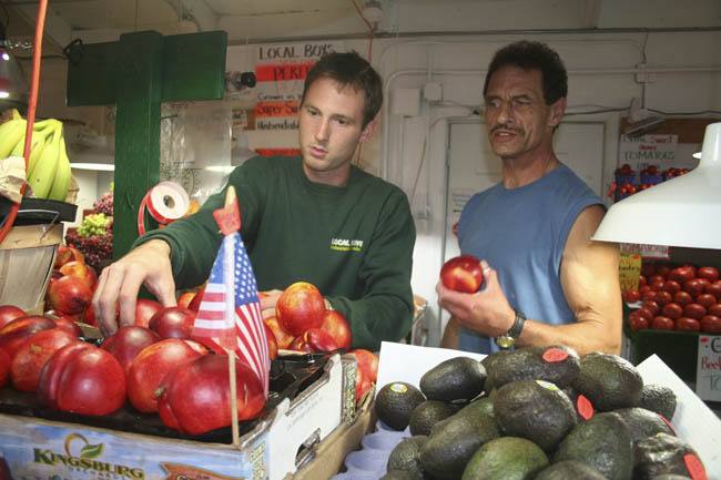 Trevor Jones and Ray Paul Schumsky inspect Local Boys’ apple bin.