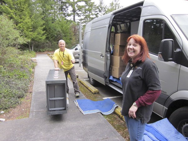 Jennifer Perryman and Vojtek Vandenberg move equipment to the new college office at Bangor.