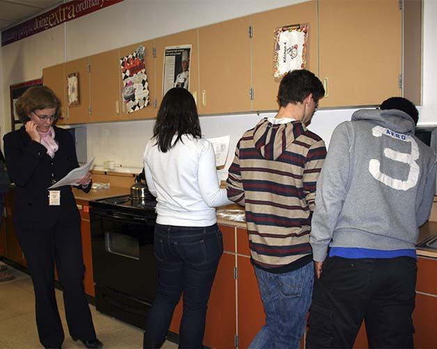 State Sen. Christine Rolfes looks over the assignment for the food science class that she visited earlier this week.