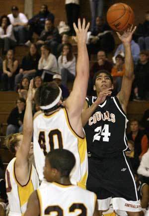 Central Kitsaps Philip Thomas floats a shot in the Cougars closer-than-it-looked 60-53 loss to South Kitsap on Friday.