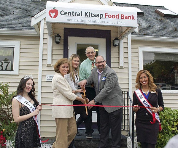 President of the Central Kitsap Food Bank Board of Directors Bob Butterton cuts the ribbon on the new CK Food Bank building last week with Sen. Christine Rolfes. Executive Director Hoyt Burrows and local dignitaries helped.