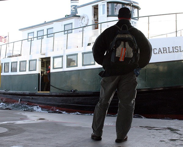 A passenger awaits the arrival of the Carlisle II in Bremerton Tuesday afternoon. Kitsap Transit is looking to expand passenger only ferry service and will hire a consultant to help.