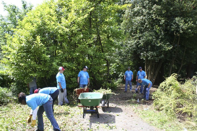 Volunteers from Submarine Group Nine at Naval Base Kitsap-Bangor work to clean up the Clear Creek Trail in Silverdale. The group is part of a larger effort by the United Way of Kitsap County to make a difference in a day in a community.