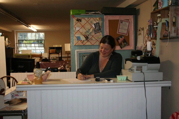 Picket Fence Market Owner Annie Gambardella works at her desk inside the market. The new vintage shop will offer classes for crafty locals who want to share ideas and project tips.