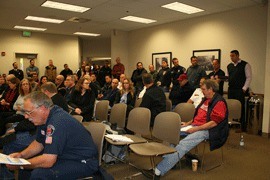 Firefighters in the CKFR District listen to union leader Ronny Smith read a statement.