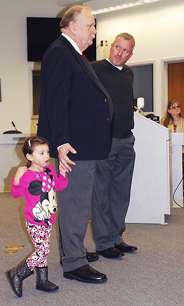 Newly sworn-in City Council member John Clauson chats with fellow councilmember Shawn Cucciardi Dec. 29 while his 3-year-old  granddaughter Ellie stays nearby.