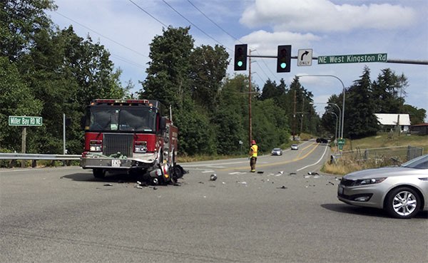 Jason Foster’s Yamaha scooter lies partially under the North Kitsap Fire & Rescue fire engine