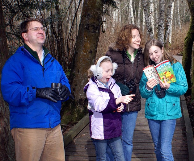 Roger and Mary Zabinski and daughters Aina and Kate go bird watching along the Clear Creek Trail in Kitsap.