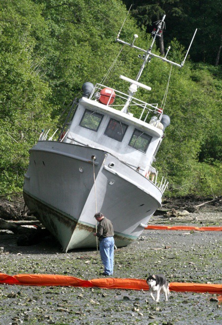 A 60-foot former navy boat rests on the beach on Port Gamble Bay on Thursday afternoon.