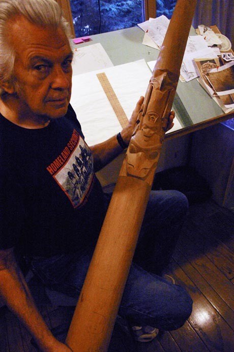Duane Pasco at his desk with a partially finished totem pole. See more of his work at www.duanepasco.com.