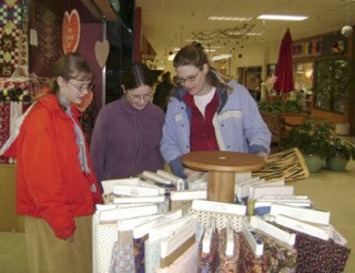 Carol Eddy (right) shops for fabric samples with two of her daughters