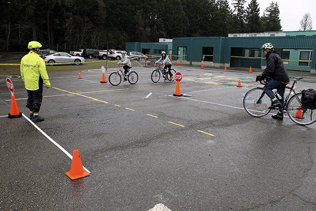 Cottonwood Elementary students Marissa Quitevis and Emalee Kylben participate in a bike rodeo during a Community Health Fair on Saturday. The rodeo was held by members of the West Sound Cycling Club.